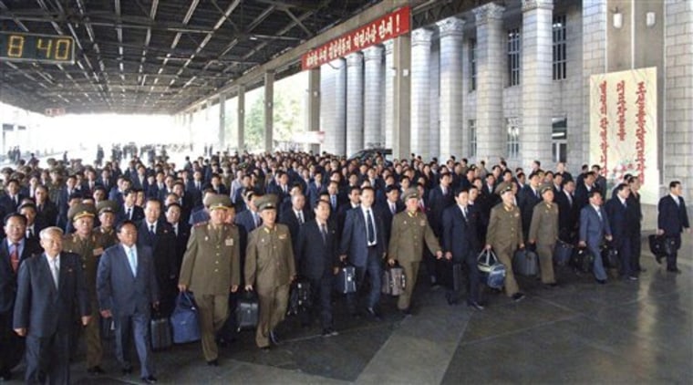 In this photo released by Korean Central News Agency via Korea News Service, delegates to the ruling Worker's Party meeting make their way upon arriving at Pyongyang station, North Korea, on Monday.